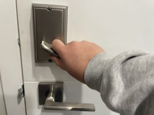 hand locking a door inside an apartment