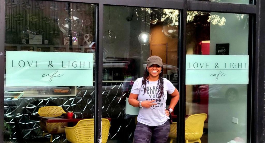 Founder standing in front of her cafe