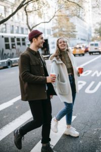 two friends using the buddy system while walking the city streets during the daytime