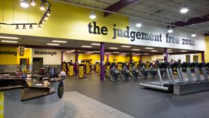 interior of planet fitness reading "judgment free zone"on the wall