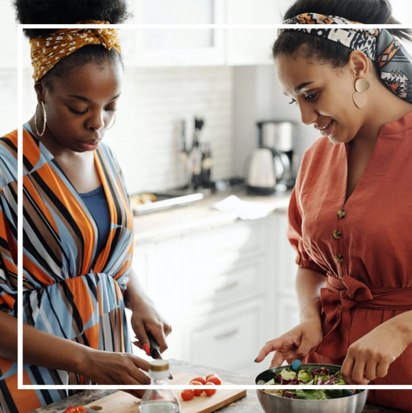 two women cooking in their apartment kitchen at Ivy Residences in Hyde Park, Chicago