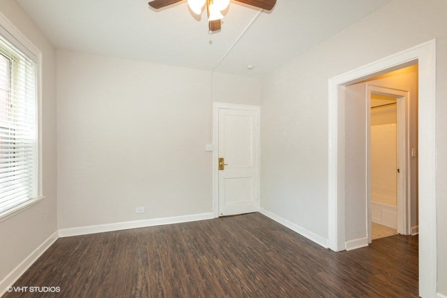 hardwood floors and ceiling fans in bright bedroom hyde park chicago apartment